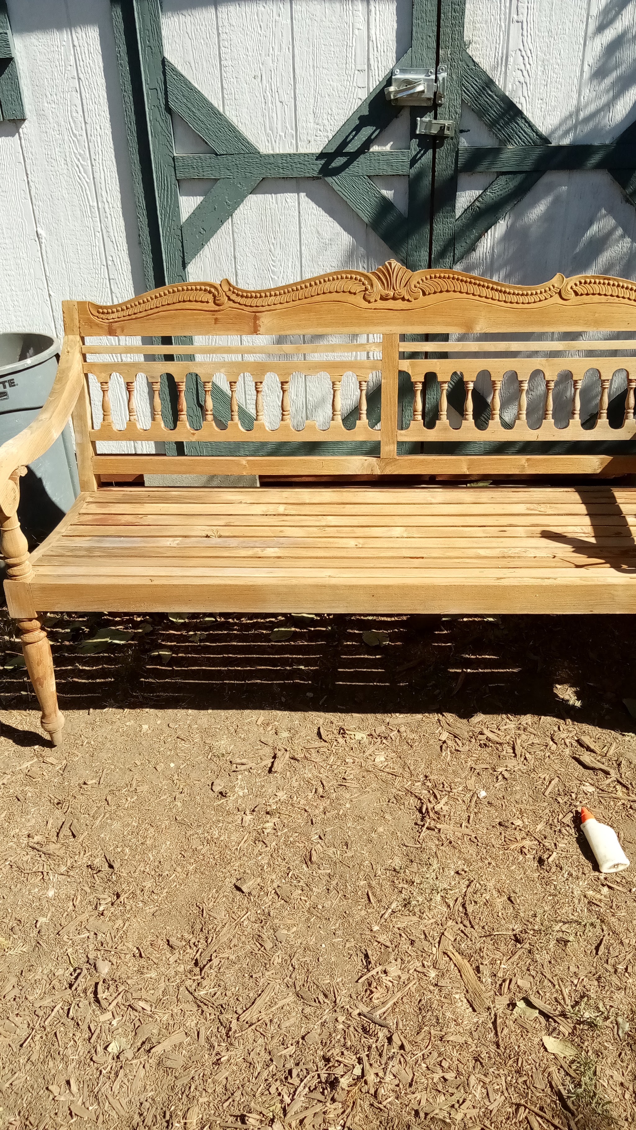 Ornately carved wooden bench refinished by Romack Home Maintenance